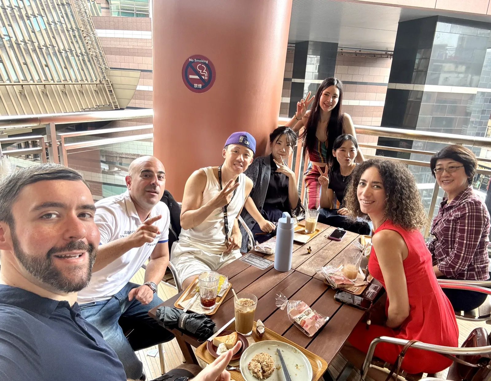 Members around a table on a café terrace